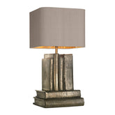 A table lamp base finished in a antique bronze look, its a stack of books, two placed flat on the bottom with another four books of differing widths standing vertically on top the lamp stand the comes up from inside the vertical books, its a cast resin base and the bronze finish is smelted in when the cast is made in the mould. A really attractive interesting lamp by David Hunt Lighting